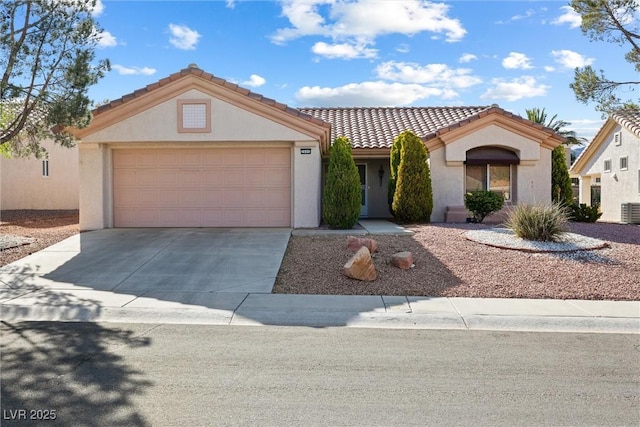 view of front of property featuring a tiled roof, central AC unit, a garage, concrete driveway, and stucco siding