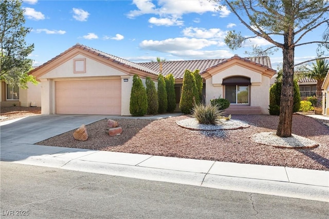 view of front of property featuring an attached garage, stucco siding, driveway, and a tiled roof