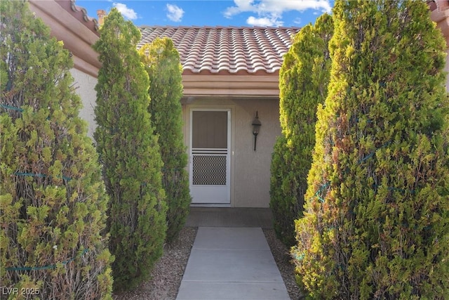 doorway to property with a tiled roof