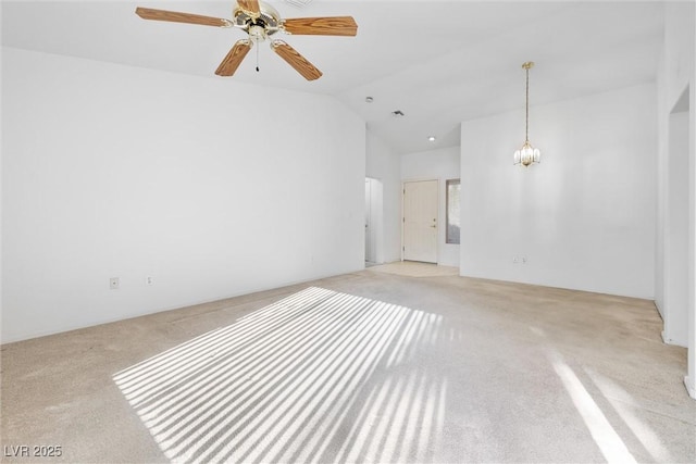 unfurnished room with light carpet, ceiling fan with notable chandelier, and lofted ceiling