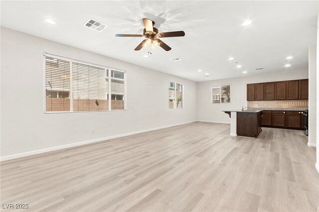 unfurnished living room with ceiling fan, light wood finished floors, recessed lighting, baseboards, and visible vents