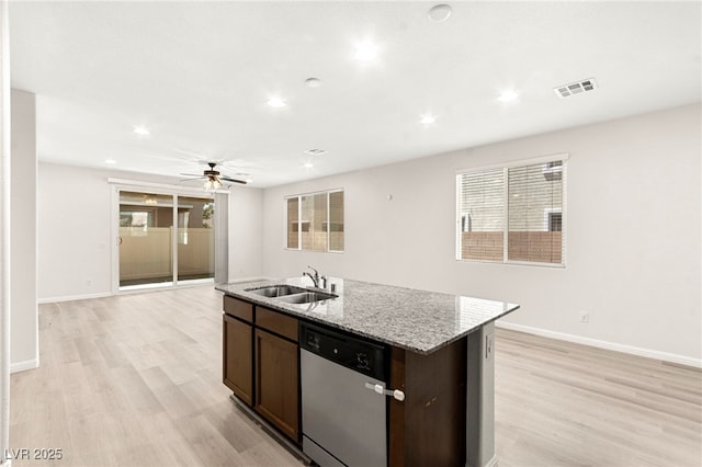 kitchen featuring ceiling fan, visible vents, dishwasher, a sink, and an island with sink