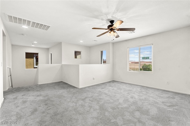 empty room featuring carpet flooring, recessed lighting, and visible vents
