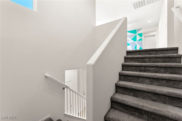 stairway featuring visible vents