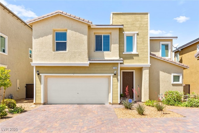view of front of property featuring a garage, stucco siding, cooling unit, decorative driveway, and a tiled roof