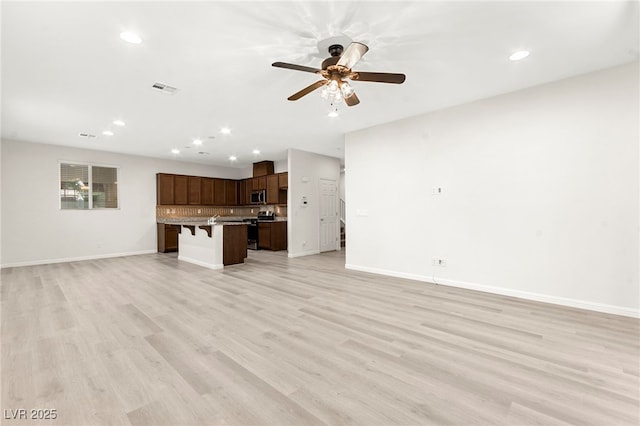 unfurnished living room featuring a ceiling fan, baseboards, visible vents, and recessed lighting