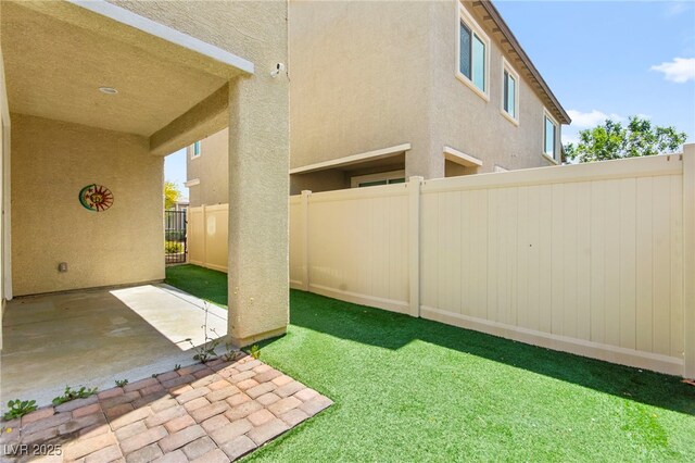 view of yard with fence and a patio area