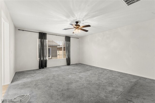 spare room with ceiling fan, visible vents, light carpet, and baseboards