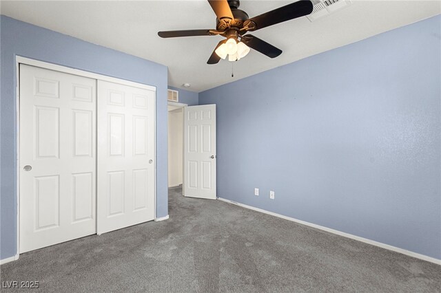 unfurnished bedroom featuring a closet, carpet, baseboards, and visible vents