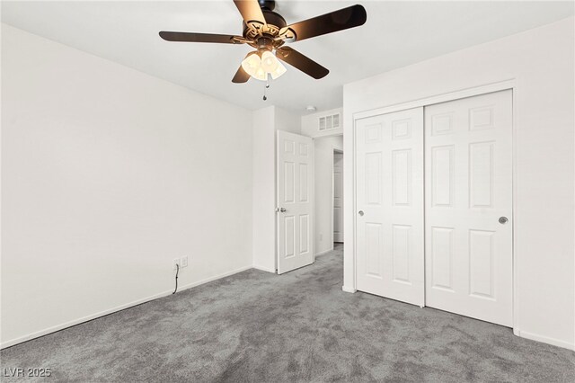 unfurnished bedroom with carpet flooring, baseboards, visible vents, and a closet