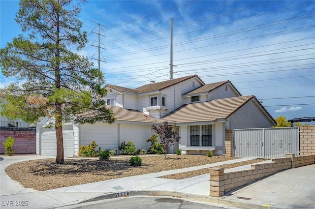 traditional home with a tiled roof, stucco siding, driveway, and fence