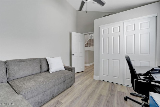 office area featuring ceiling fan, lofted ceiling, light wood-type flooring, and visible vents