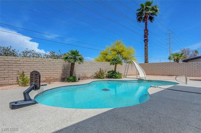 view of pool featuring a fenced backyard, a patio, a fenced in pool, and a water slide