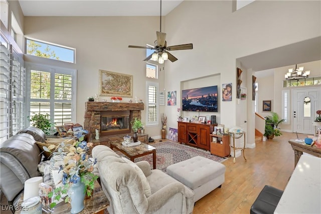 2909 Sterling Cove Dr, Las Vegas, NV 89128 - living area with light wood-style flooring, a fireplace, a wealth of natural light, and high vaulted ceiling