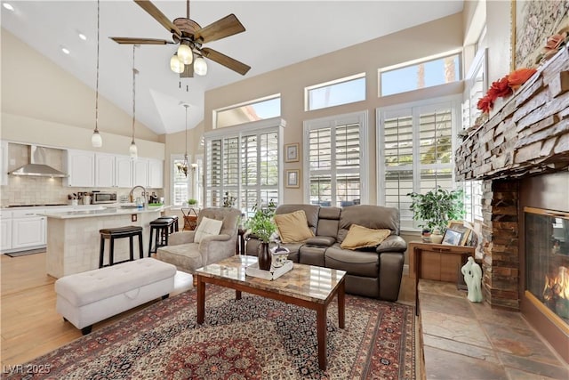 2909 Sterling Cove Dr, Las Vegas, NV 89128 - living room with high vaulted ceiling, ceiling fan, and a fireplace