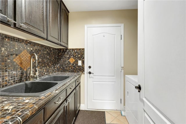 2909 Sterling Cove Dr, Las Vegas, NV 89128 - clothes washing area with a sink, washer / dryer, and light tile patterned floors