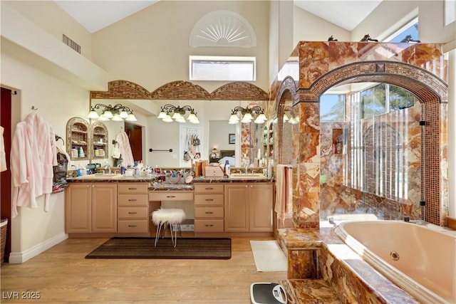 2909 Sterling Cove Dr, Las Vegas, NV 89128 - full bathroom with a whirlpool tub, high vaulted ceiling, wood finished floors, and vanity