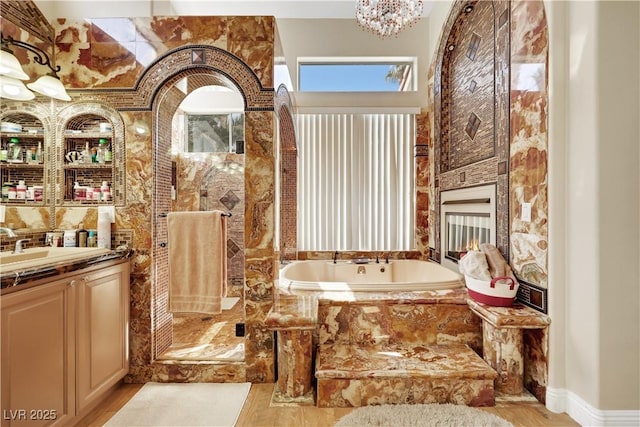 2909 Sterling Cove Dr, Las Vegas, NV 89128 - bathroom featuring vanity, a garden tub, and wood finished floors