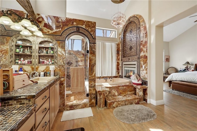 2909 Sterling Cove Dr, Las Vegas, NV 89128 - bathroom featuring a garden tub, wood finished floors, a walk in shower, baseboards, and a chandelier