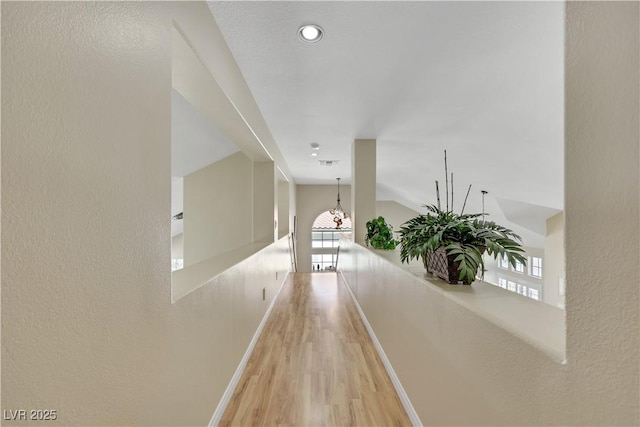 2909 Sterling Cove Dr, Las Vegas, NV 89128 - hall with baseboards, visible vents, an inviting chandelier, and light wood-type flooring