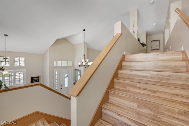 2909 Sterling Cove Dr, Las Vegas, NV 89128 - stairway featuring an inviting chandelier, high vaulted ceiling, and wood finished floors