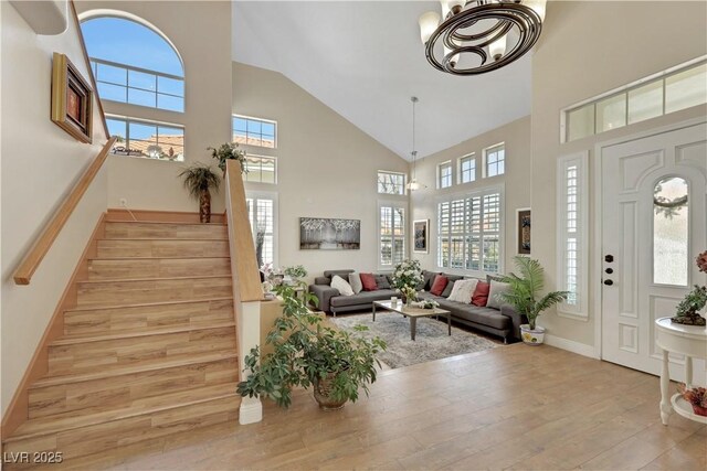 2909 Sterling Cove Dr, Las Vegas, NV 89128 - foyer featuring light wood-style floors, high vaulted ceiling, stairs, and a healthy amount of sunlight