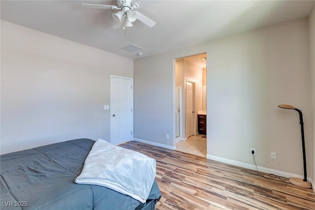 unfurnished bedroom featuring baseboards, light wood finished floors, ceiling fan, and visible vents