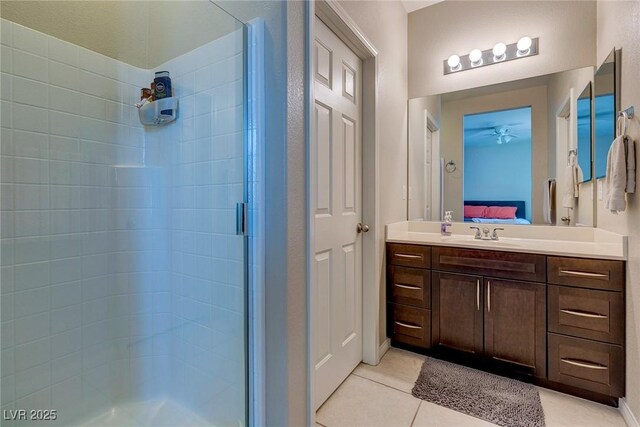 bathroom with vanity, tile patterned floors, a shower stall, and ensuite bath