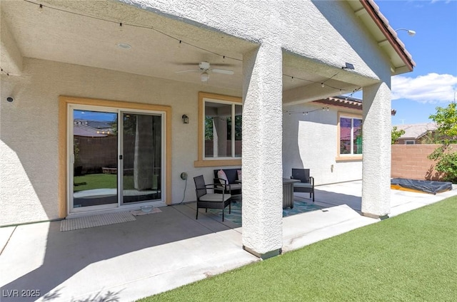 view of patio / terrace with ceiling fan, fence, and an outdoor hangout area