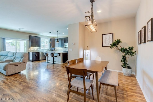 dining room with recessed lighting, light wood-style flooring, and visible vents