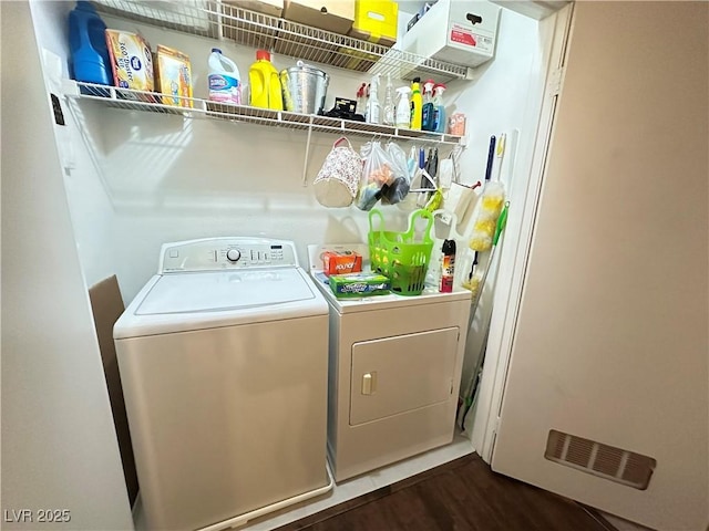 698 S Racetrack Rd Unit 322, Henderson, NV 89015 - washroom with dark wood-style flooring, laundry area, visible vents, and washing machine and dryer