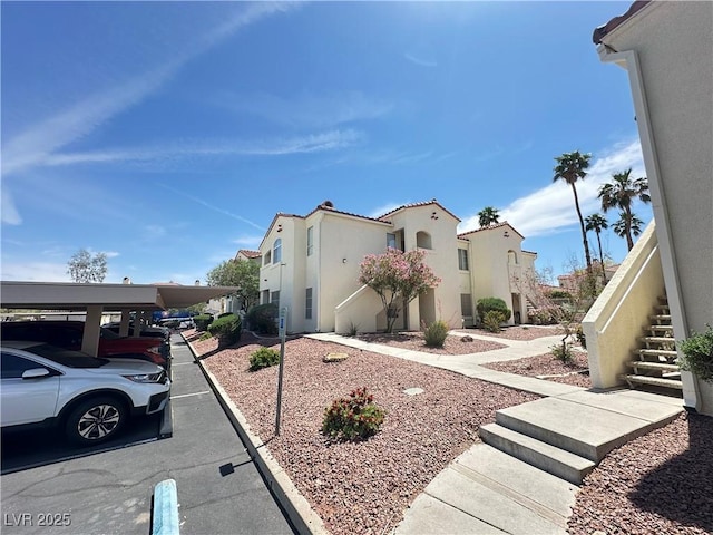 698 S Racetrack Rd Unit 322, Henderson, NV 89015 - view of home's exterior featuring covered parking, a residential view, and stucco siding