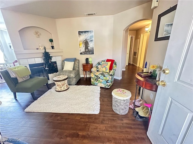 698 S Racetrack Rd Unit 322, Henderson, NV 89015 - living room with arched walkways, baseboards, wood finished floors, and visible vents
