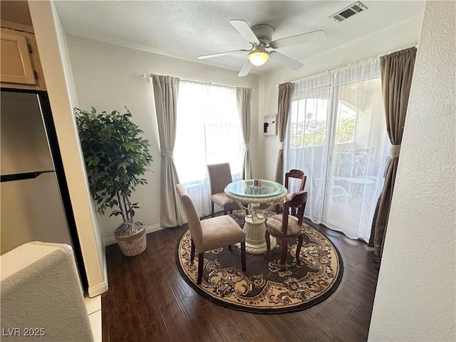 698 S Racetrack Rd Unit 322, Henderson, NV 89015 - dining area with visible vents, a ceiling fan, baseboards, and wood finished floors