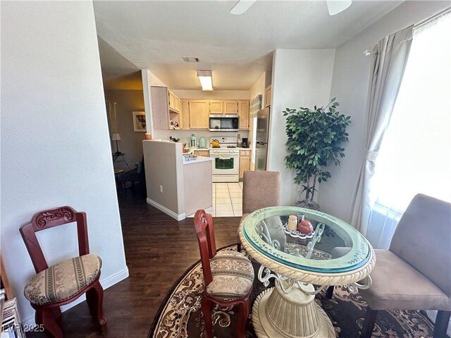 698 S Racetrack Rd Unit 322, Henderson, NV 89015 - dining area with dark wood-style flooring, baseboards, visible vents, and a ceiling fan
