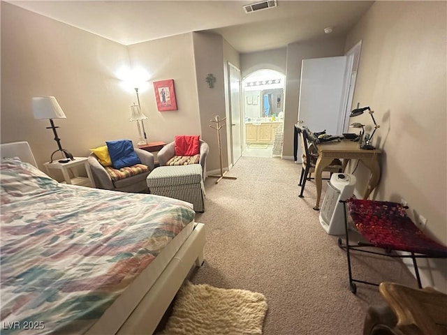 698 S Racetrack Rd Unit 322, Henderson, NV 89015 - bedroom with baseboards, ensuite bathroom, light carpet, and visible vents