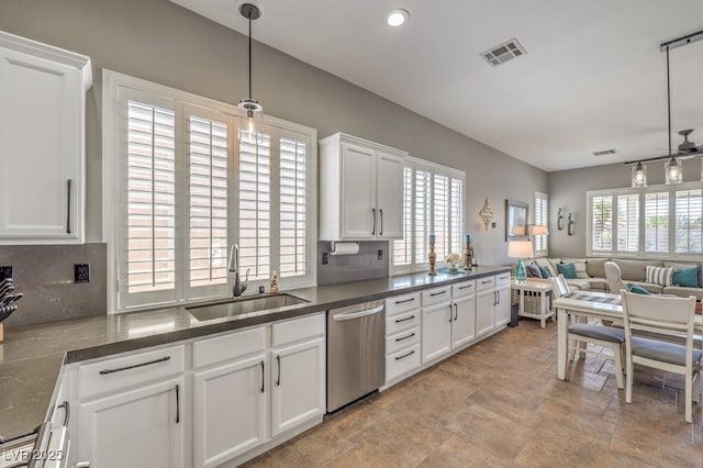 kitchen featuring a sink, stone finish floor, open floor plan, stainless steel dishwasher, and visible vents
