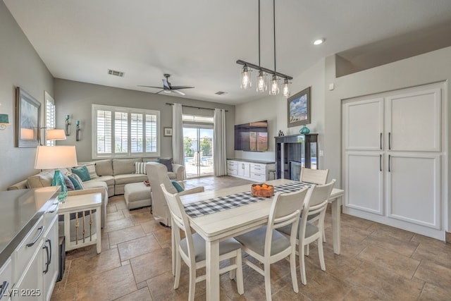 dining space with visible vents, stone tile floors, ceiling fan, and recessed lighting