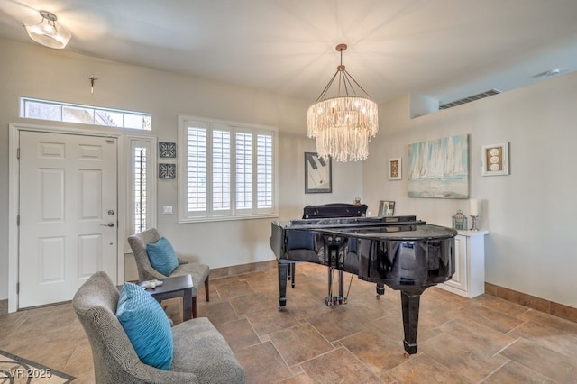 sitting room featuring baseboards, visible vents, and an inviting chandelier