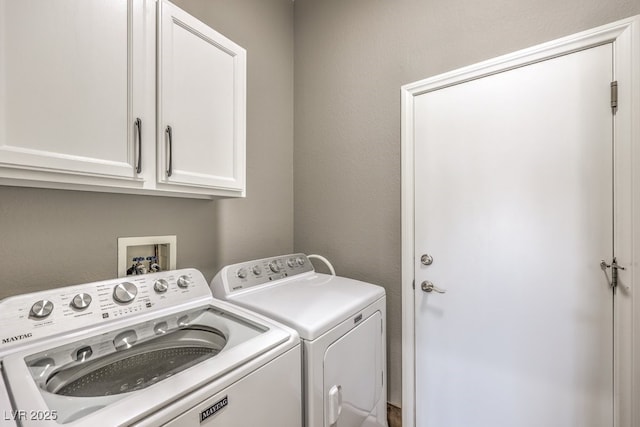 laundry room with cabinet space and separate washer and dryer