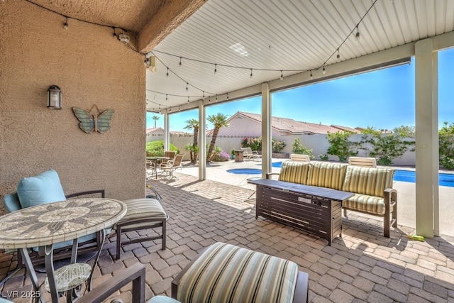view of patio / terrace featuring a fenced in pool, outdoor dining space, an outdoor living space, and a fenced backyard