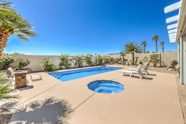 view of pool featuring a patio, an in ground hot tub, a fenced in pool, and a fenced backyard
