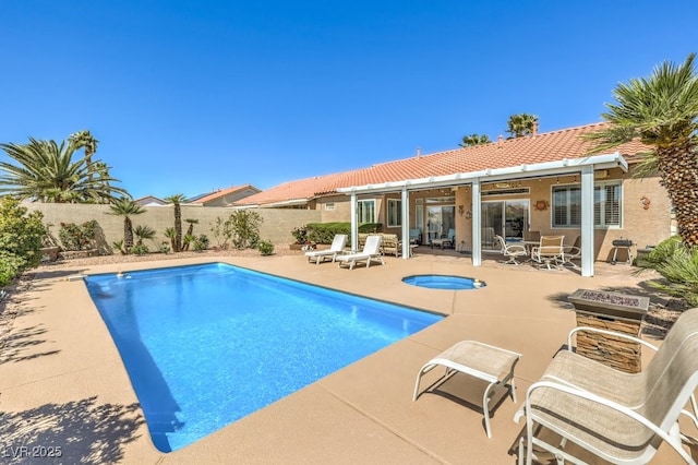 view of pool featuring an in ground hot tub, a fenced in pool, a fenced backyard, and a patio area
