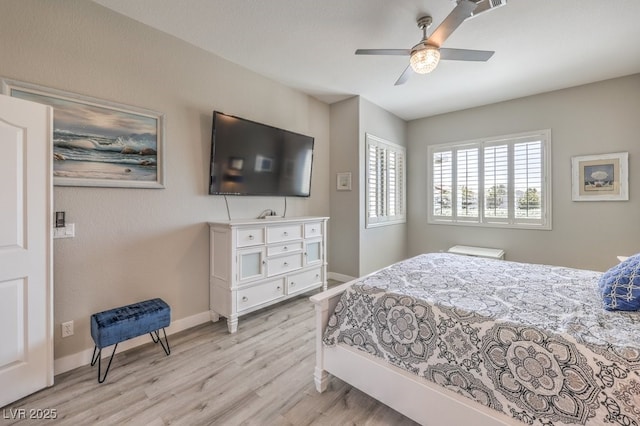 bedroom with light wood-type flooring, baseboards, and ceiling fan