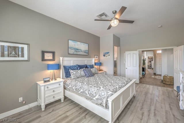 bedroom with baseboards, ceiling fan, light wood-style flooring, and visible vents