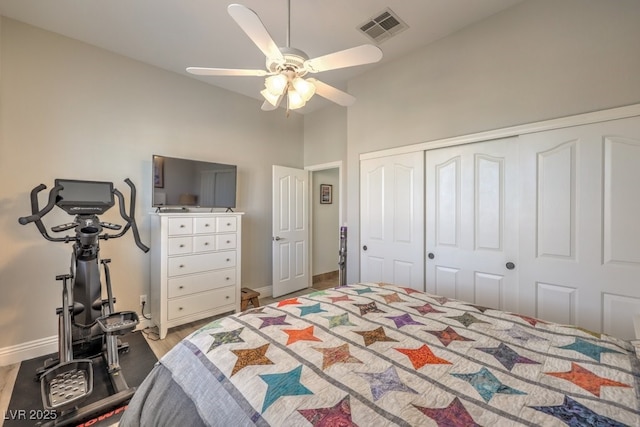 bedroom featuring visible vents, baseboards, a high ceiling, and a closet