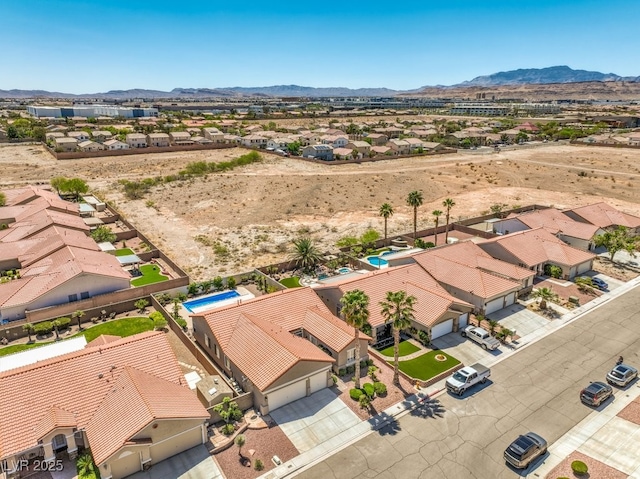 aerial view featuring a residential view, a mountain view, and view of desert
