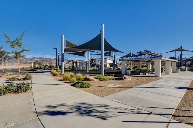 surrounding community featuring a mountain view, a gazebo, and playground community