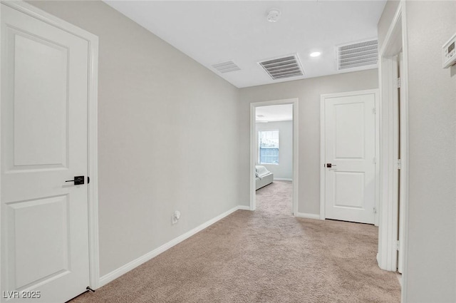 unfurnished room with baseboards, carpet flooring, and visible vents
