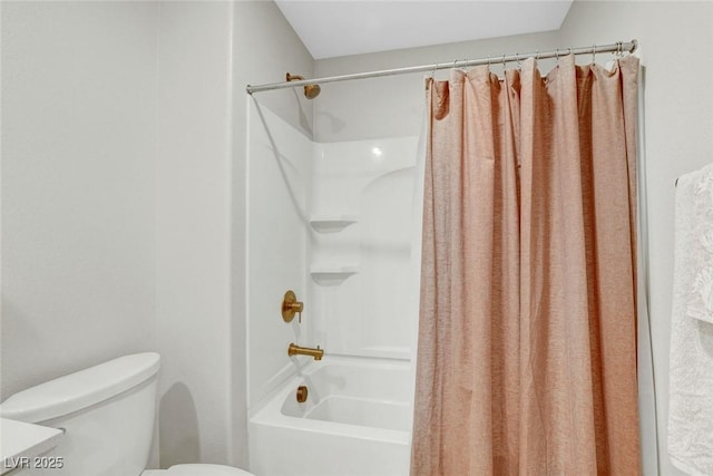 bathroom featuring shower / bath combo with shower curtain and toilet
